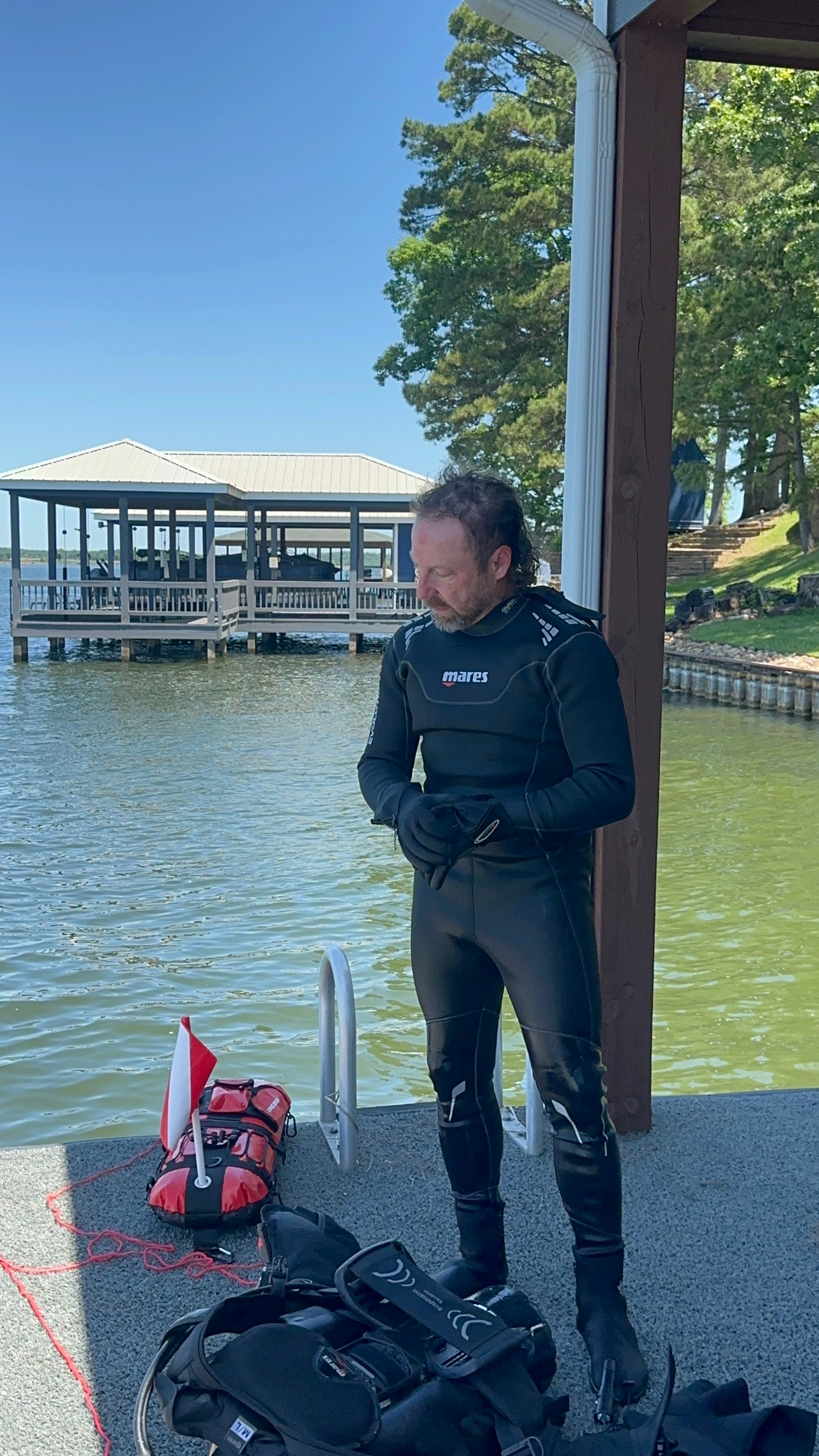 Pre-dive gear check at a private dock